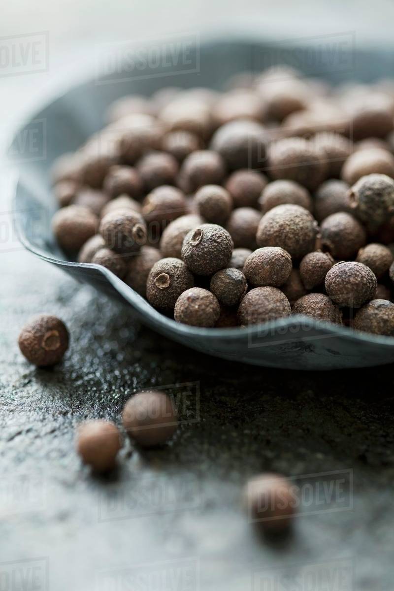 Allspice berries in a small bowl Stock Photo Dissolve