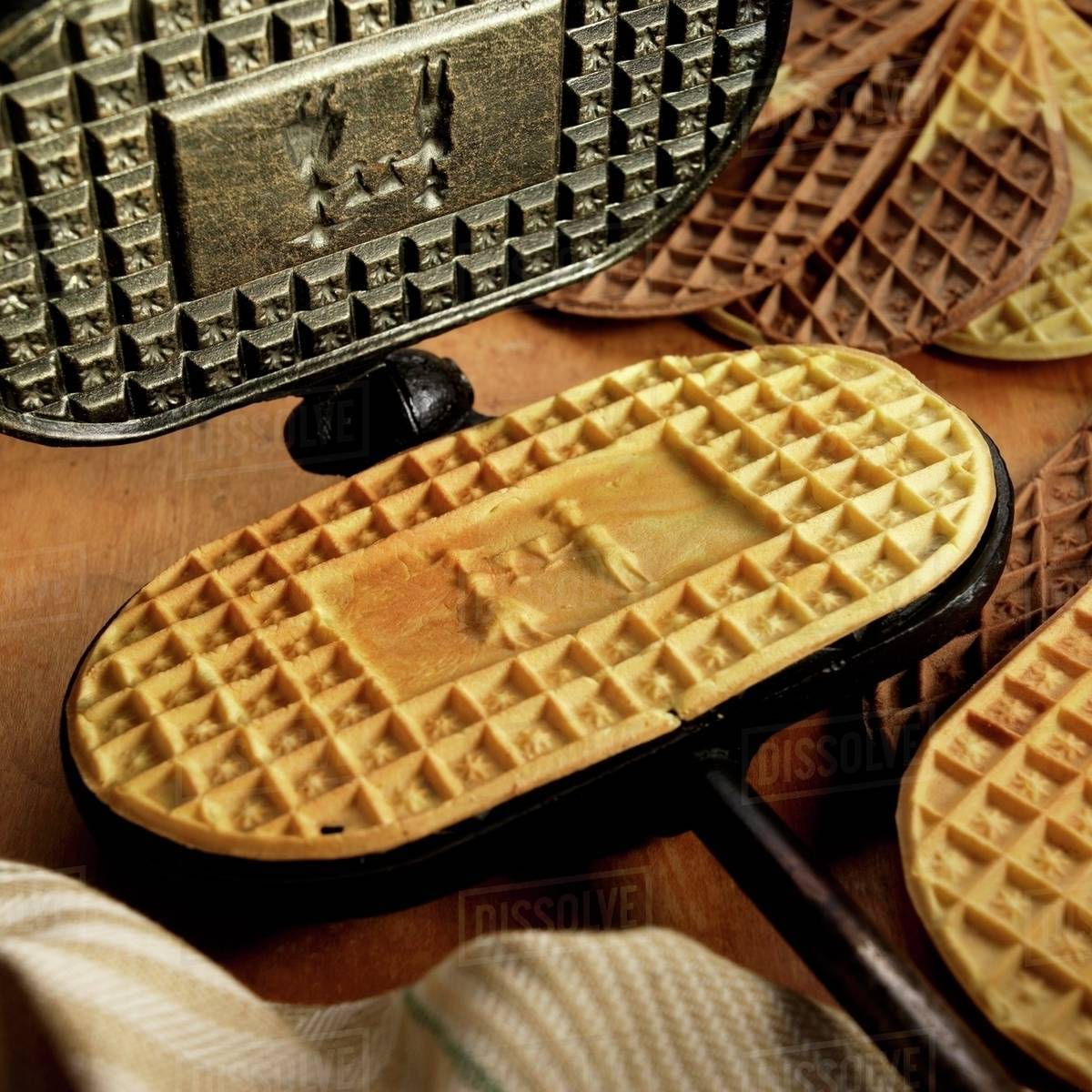 Homemade Pizzelles with Antique Iron Press Stock Photo Dissolve