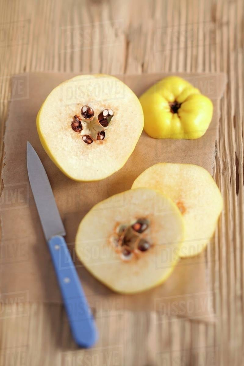 A quince cut into slices Stock Photo Dissolve