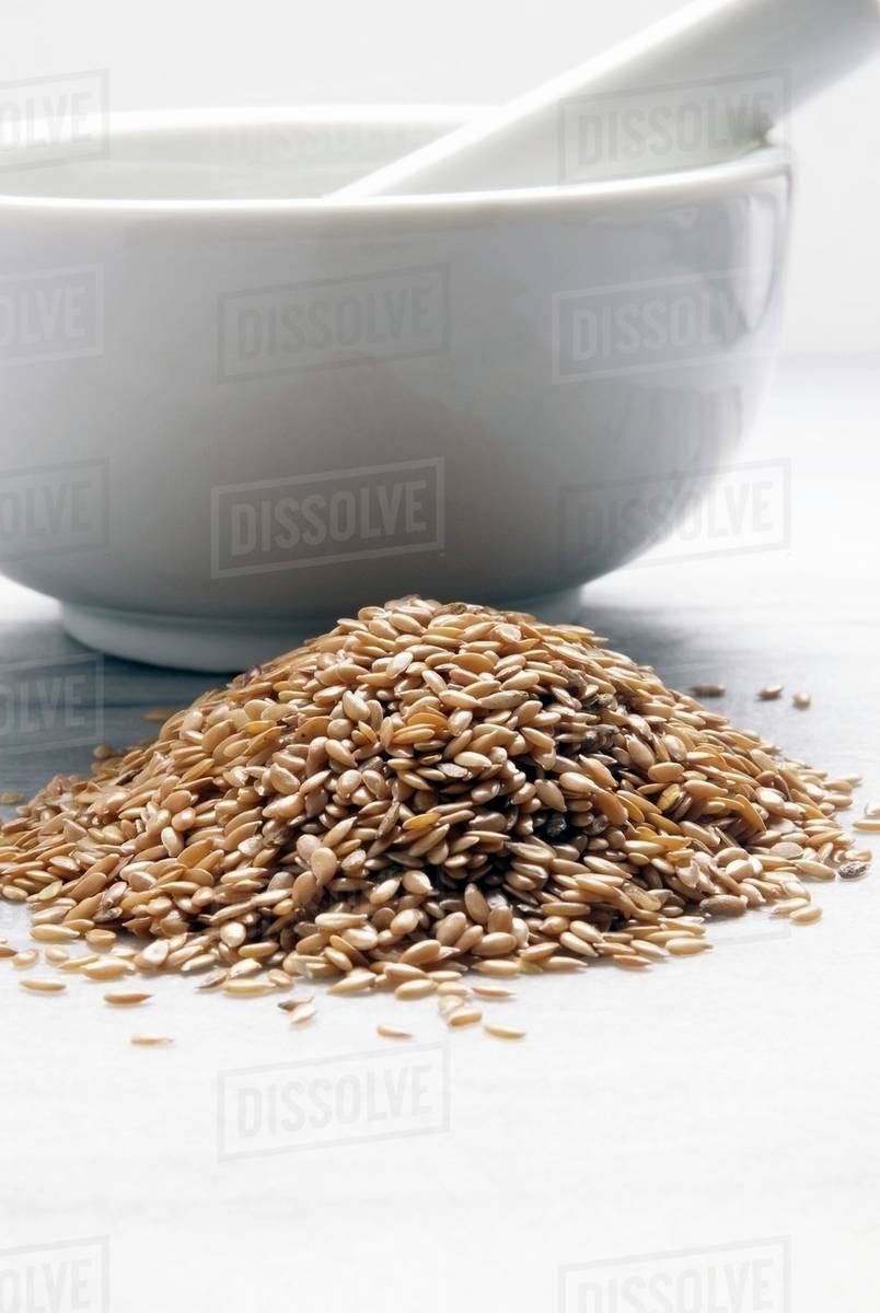 Organic Golden Flax Seeds; Mortar and Pestle Stock Photo Dissolve
