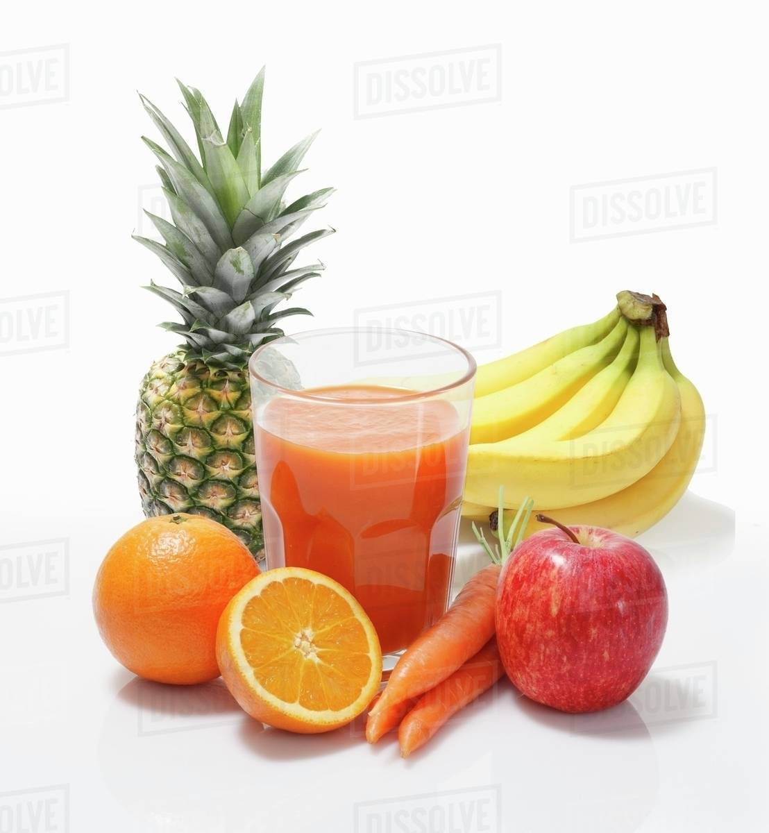 Multivitamin juice surrounded by whole fruits Stock Photo Dissolve