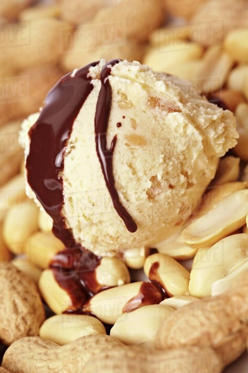 Peanut ice cream with roasted peanuts and chocolate sauce Stock Photo Dissolve