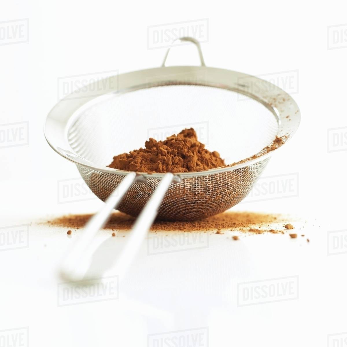 Cocoa powder in a sieve Stock Photo Dissolve