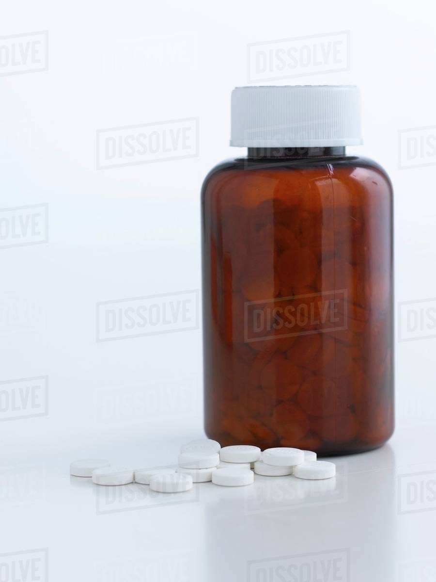 Tablets in a dispensing bottle Stock Photo Dissolve