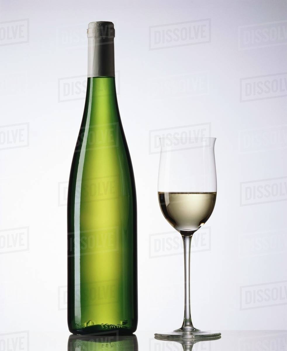 Glass and bottle of white wine Stock Photo Dissolve
