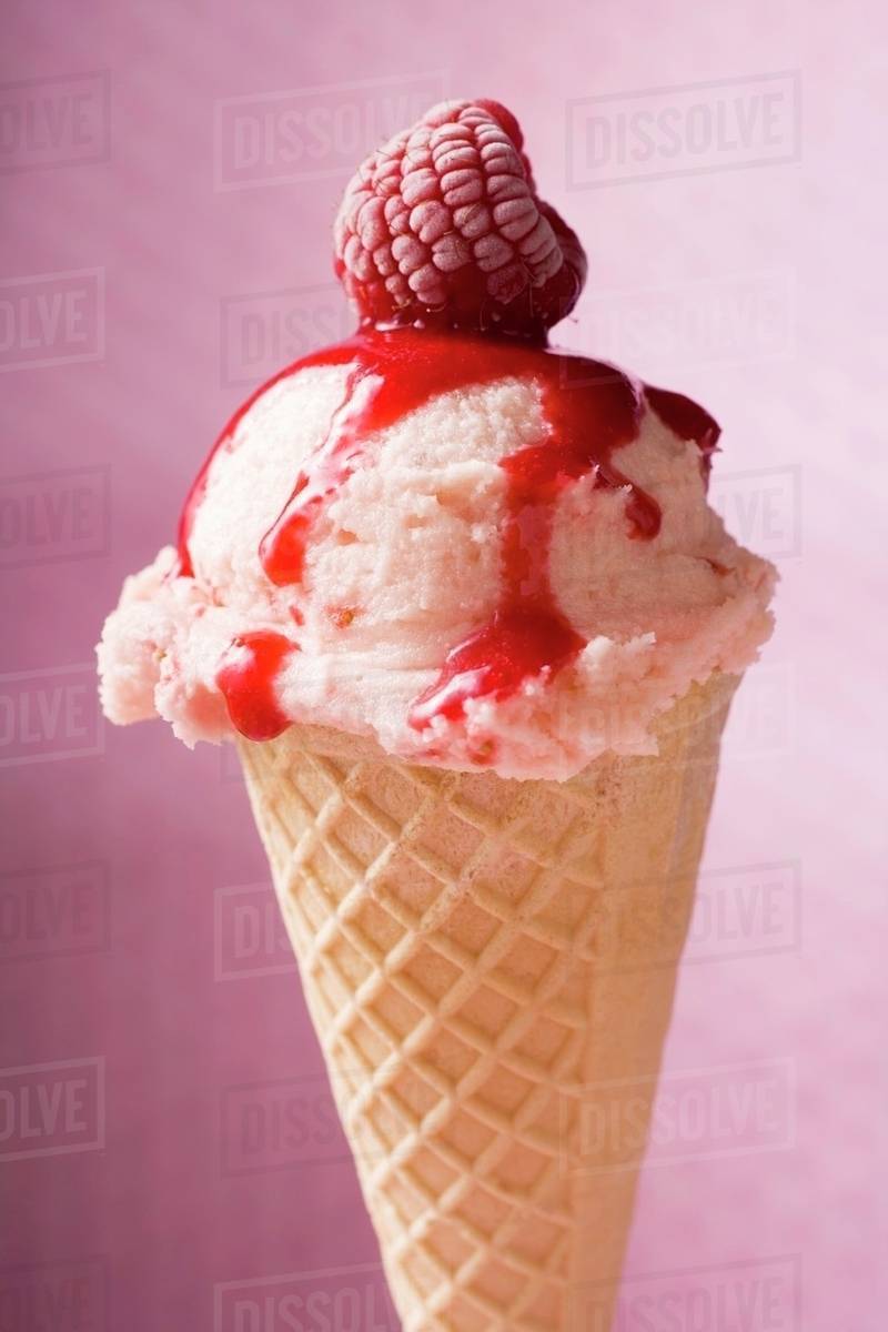 Ice cream with raspberry and raspberry sauce in wafer cone - Royalty ...
