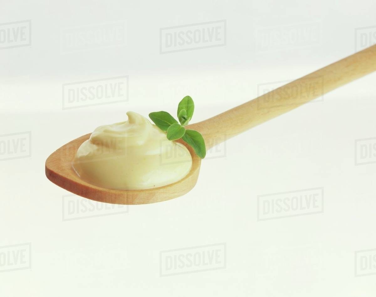 Mayonnaise on spoon Stock Photo Dissolve