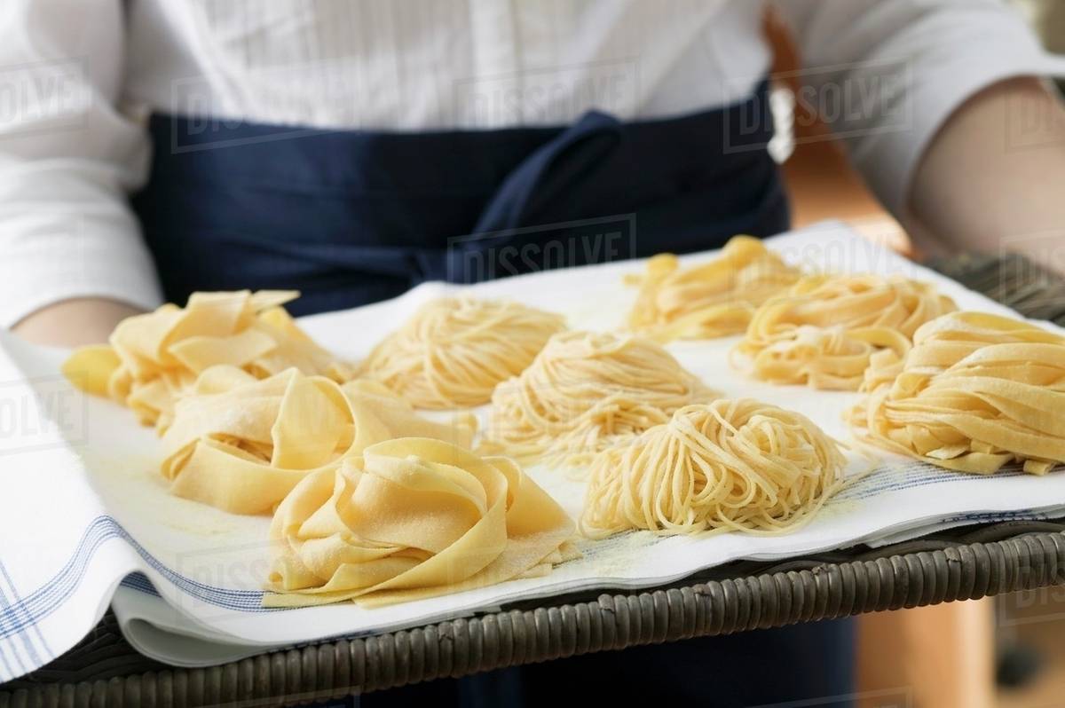 Three types of ribbon pasta on a tray Stock Photo Dissolve