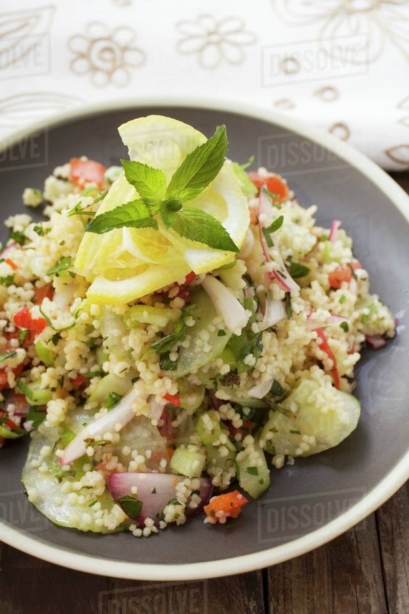 Couscous salad with vegetables, lemon and mint Stock Photo Dissolve