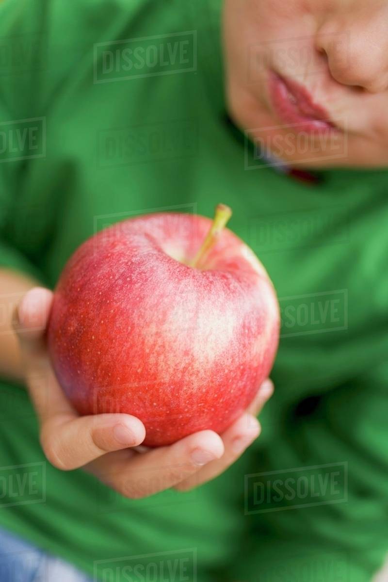 Child eating a Gala apple Stock Photo Dissolve