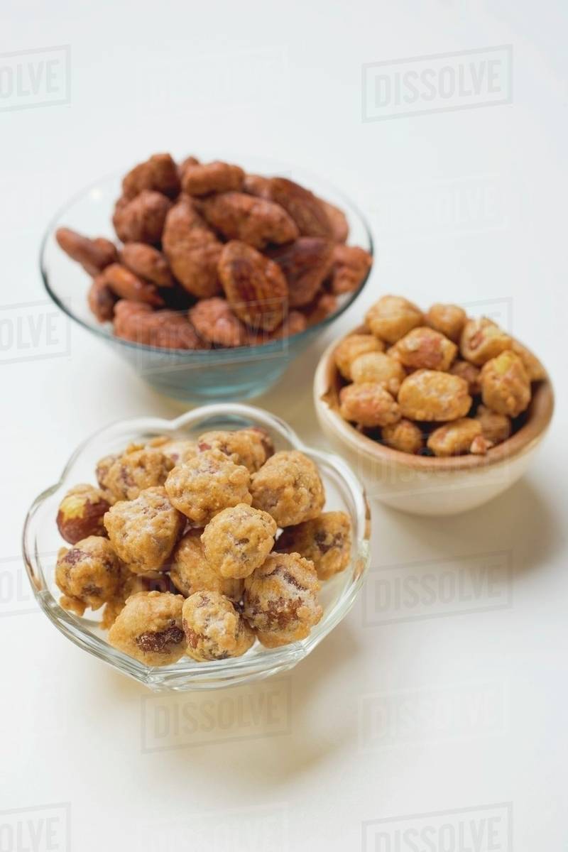 Assorted nuts to nibble in bowls Stock Photo Dissolve