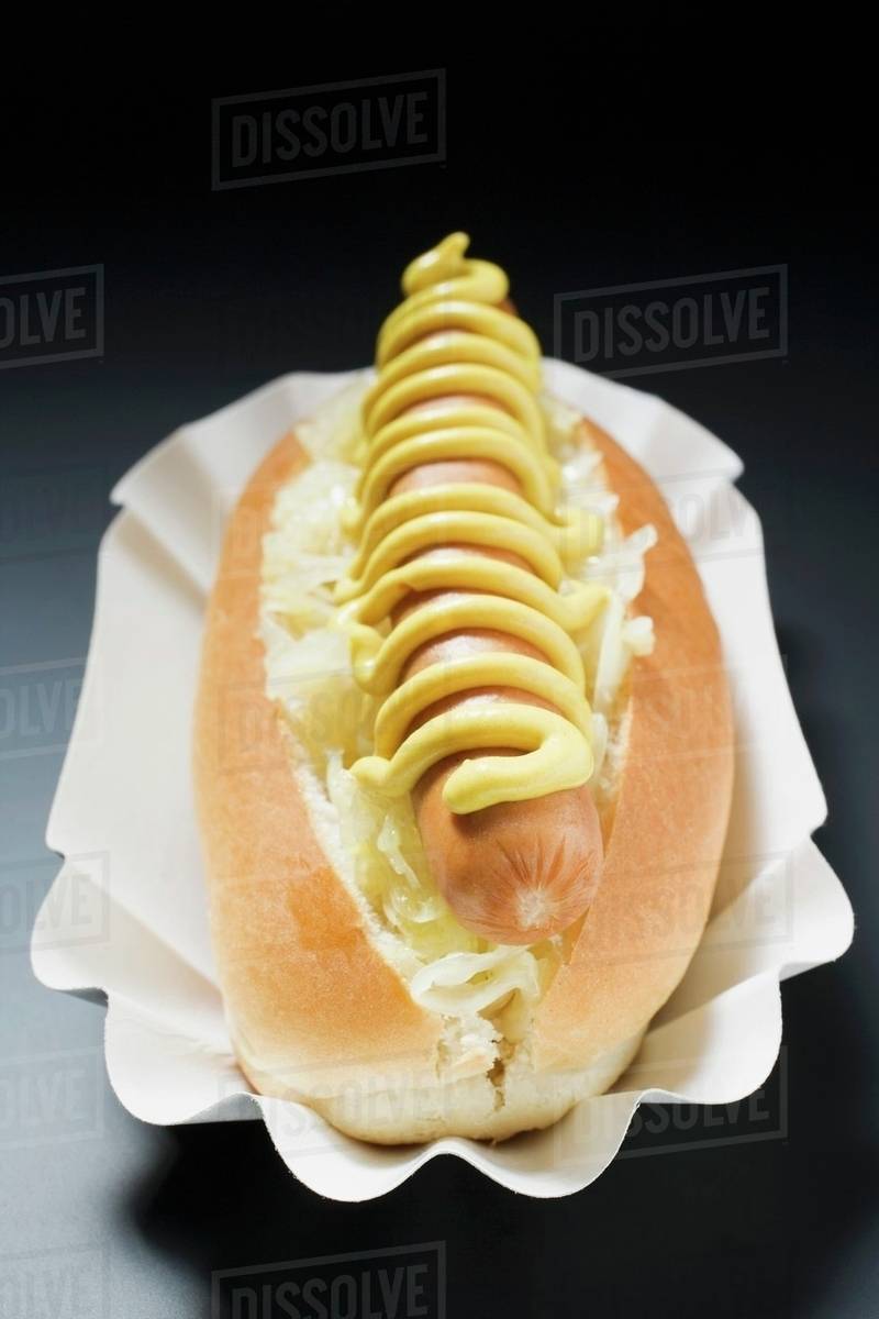 Hot dog with sauerkraut and mustard in paper dish Stock Photo Dissolve