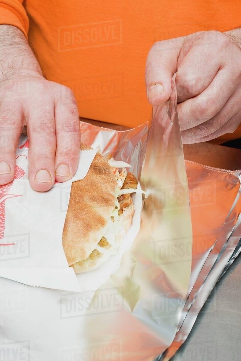 Packing a doner kebab in aluminium foil Stock Photo Dissolve