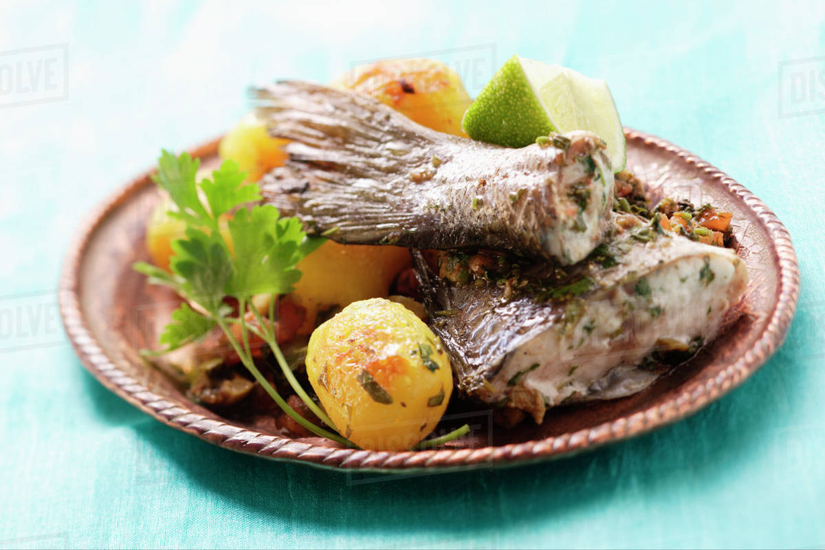 Sea bass with roast potatoes (Morocco) Stock Photo Dissolve