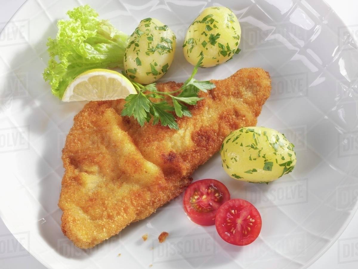 Wiener Schnitzel (veal escalope) with parsley potatoes Stock Photo