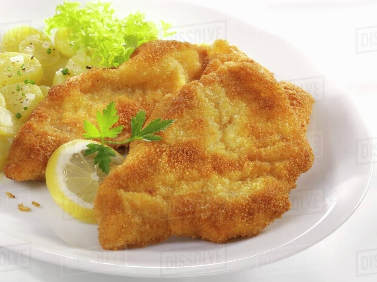 Wiener Schnitzel (veal escalope) with potato salad Stock Photo Dissolve