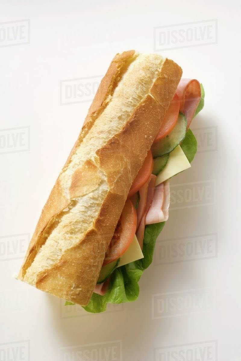 Baguette with ham, cheese, tomato, cucumber and lettuce Stock Photo