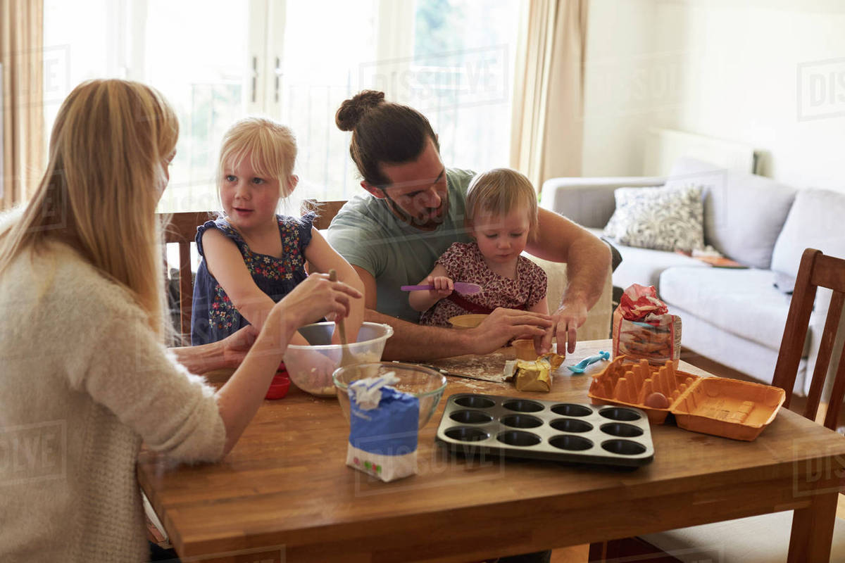 Family at home baking cakes together Stock Photo Dissolve