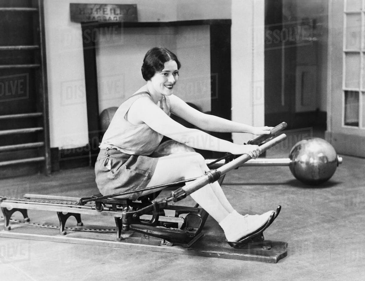 Woman using rowing machine - Royalty-free Stock Photo | Dissolve