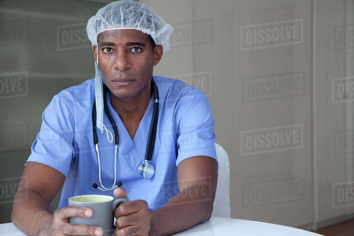 Black doctor in scrubs and surgical cap Stock Photo Dissolve