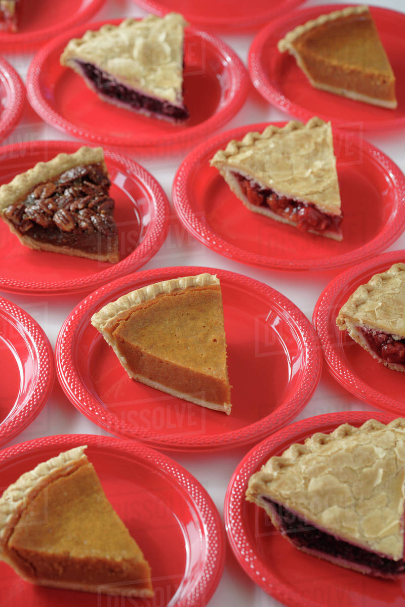Variety of slices of pie on plates Stock Photo Dissolve