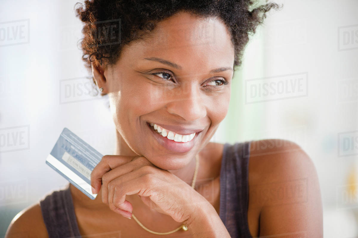 Black woman holding credit card Stock Photo Dissolve