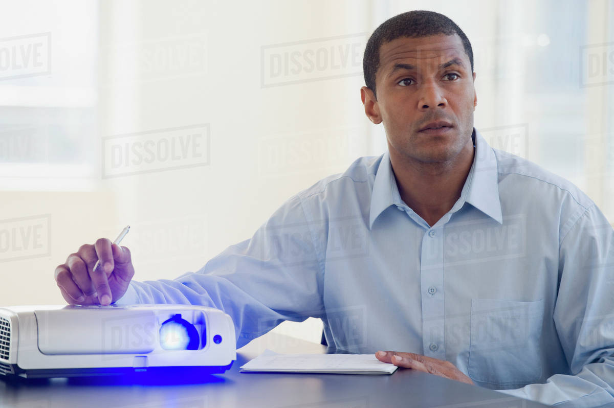 African man working slide projector Stock Photo Dissolve