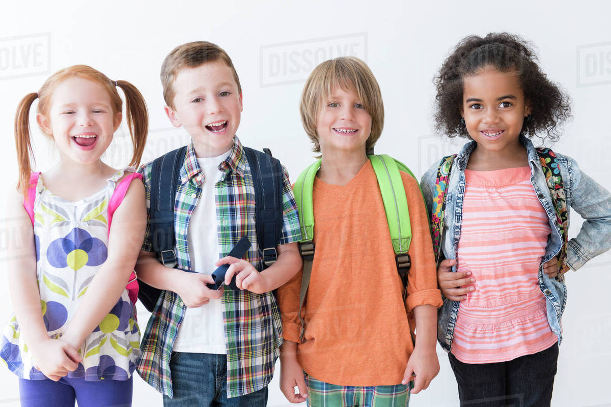 Smiling children wearing backpacks Stock Photo Dissolve