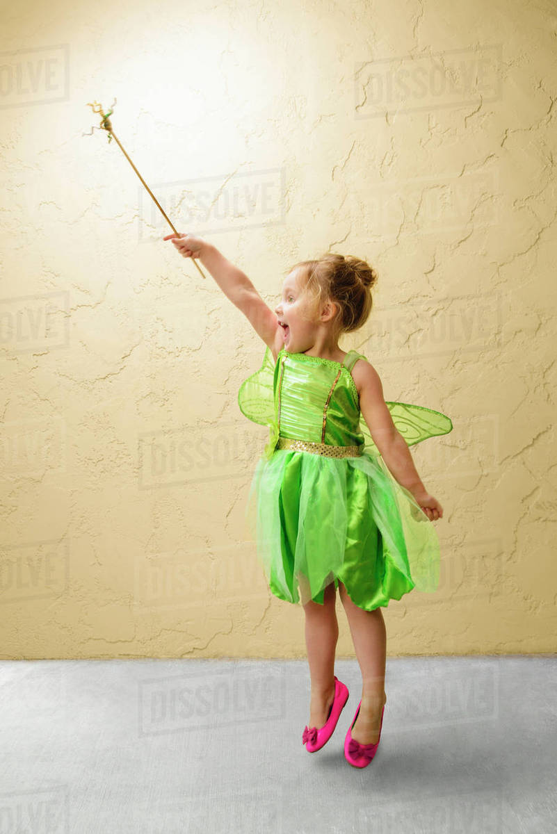Girl wearing green fairy costume with wand Royalty-free stock photo