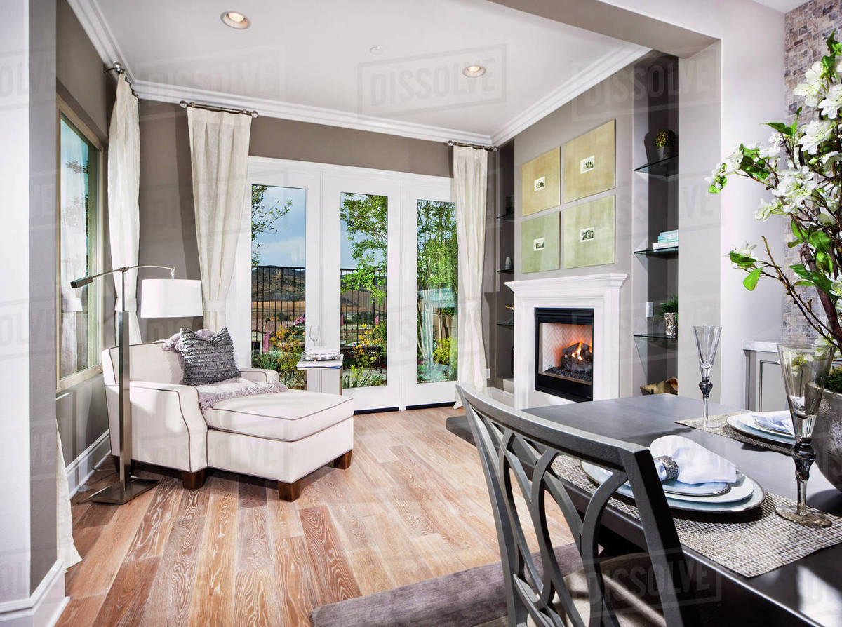 Sunroom with easy chair and footstool in house Stock Photo Dissolve