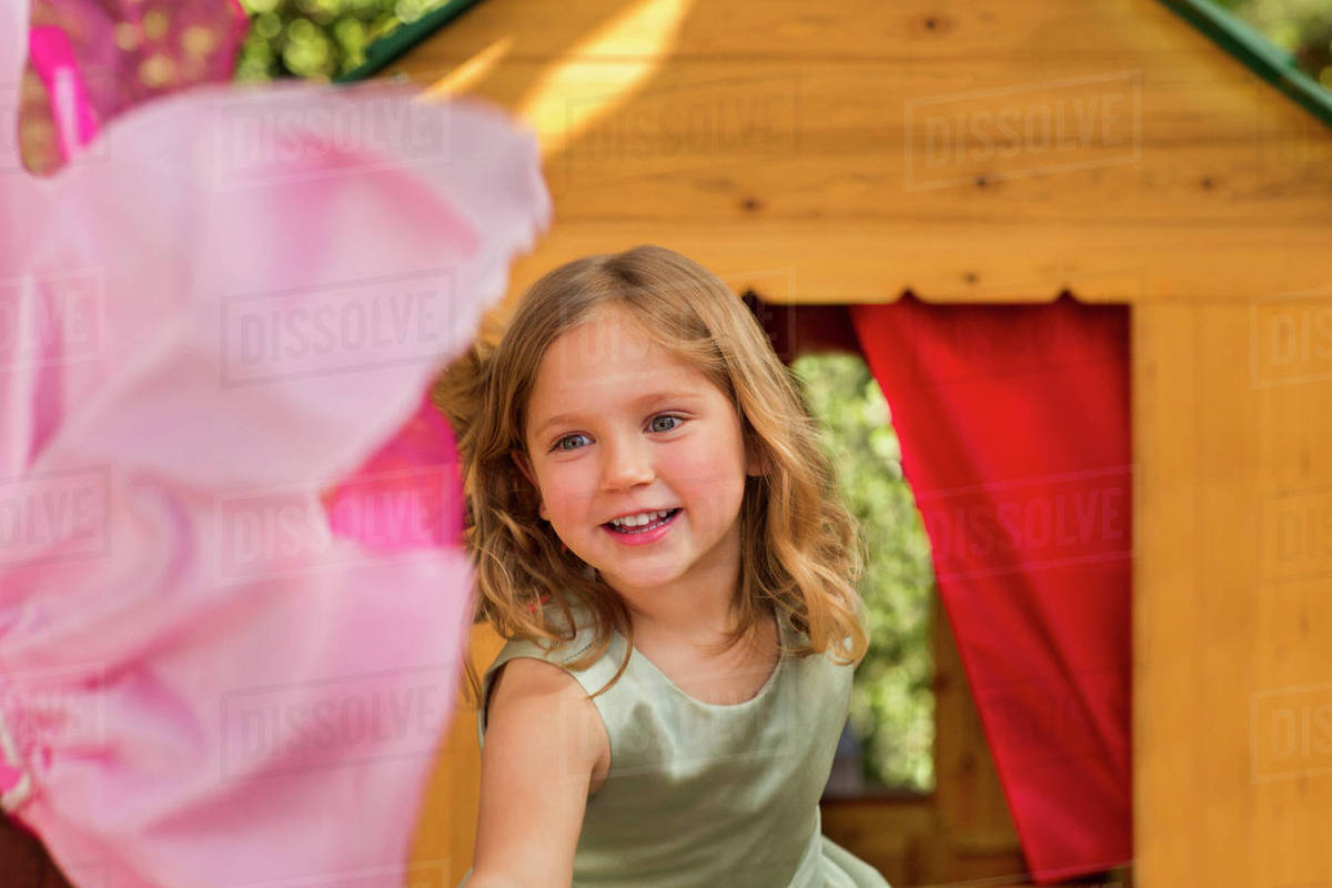 Smiling girl in playhouse Stock Photo Dissolve