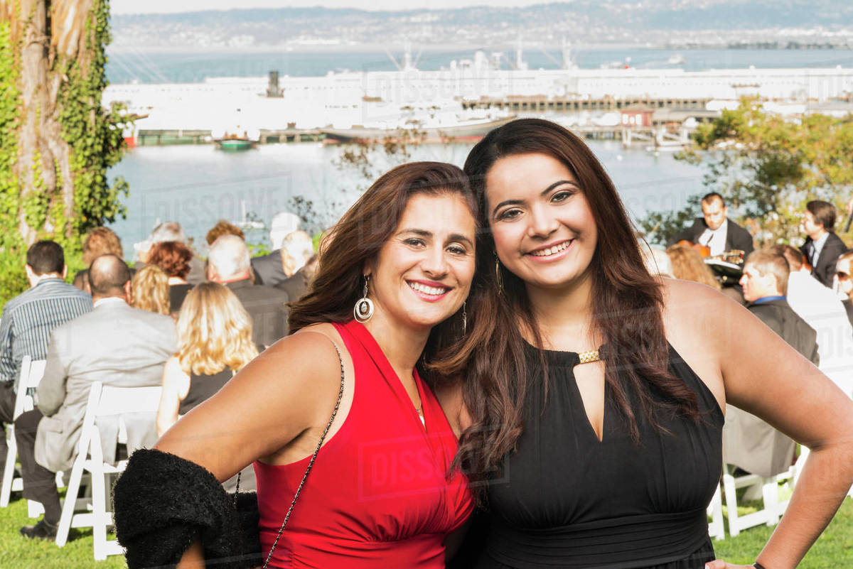 Hispanic Mother And Daughter Smiling At Wedding Stock Photo Dissolve