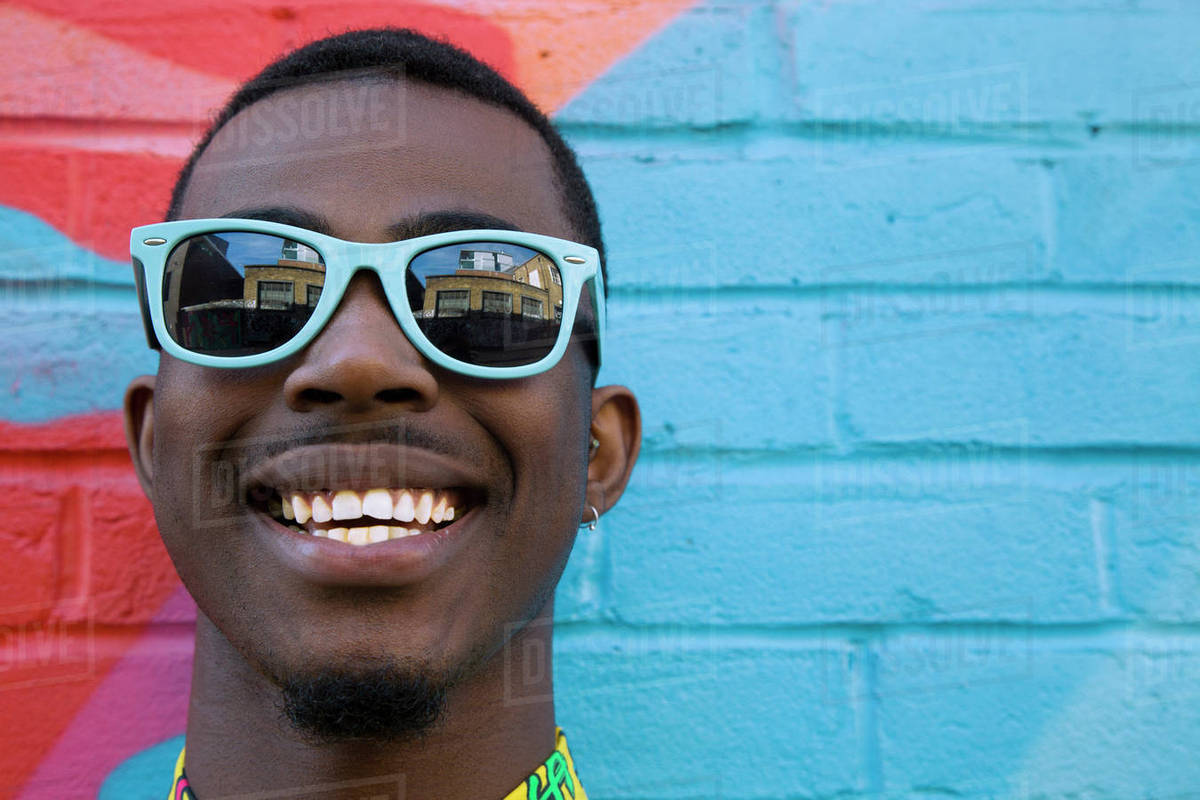 Close up of Black man wearing colorful sunglasses Stock Photo Dissolve
