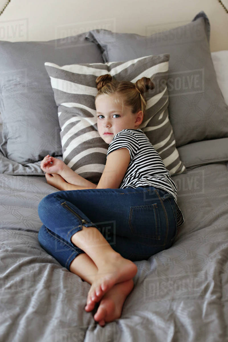 High angle view of girl laying on bed Stock Photo Dissolve