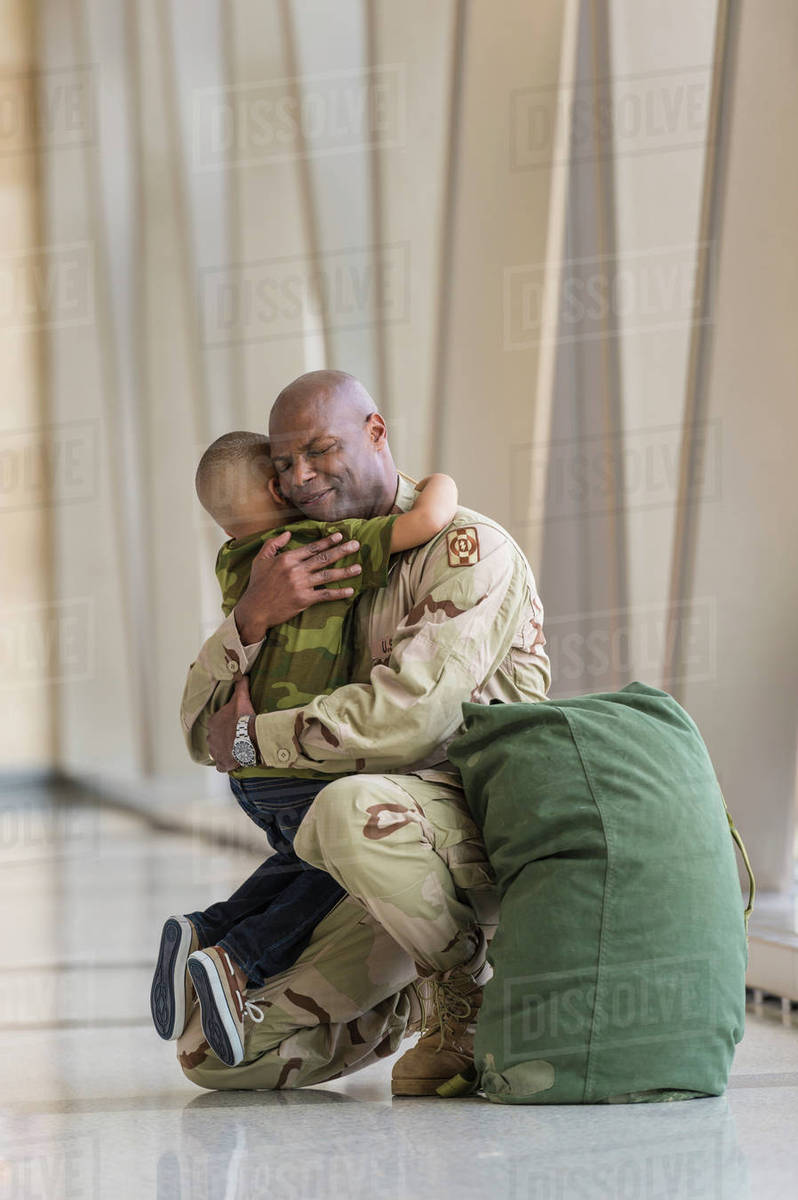 african american soldier hugging