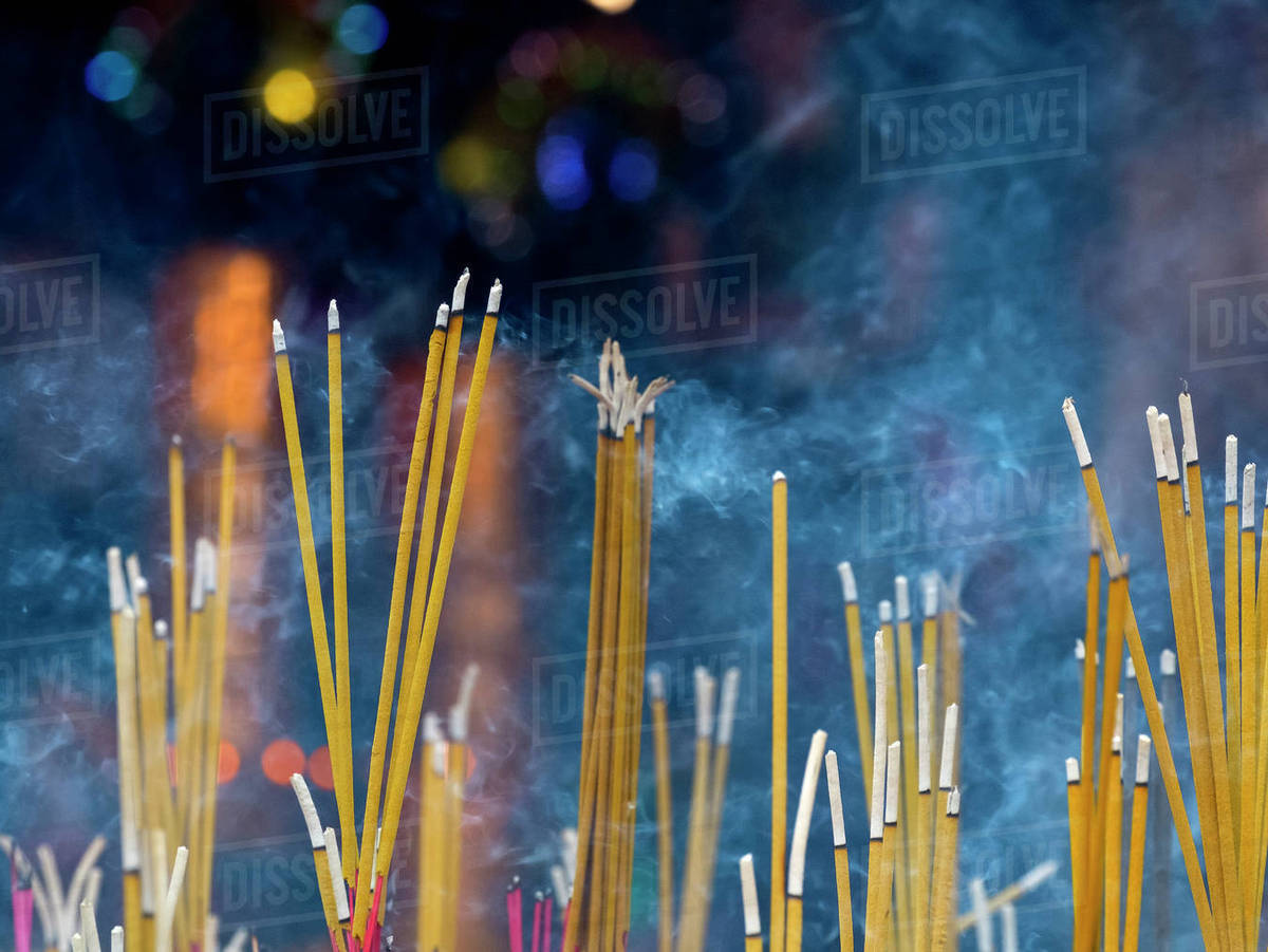 Close up of incense sticks burning Stock Photo Dissolve