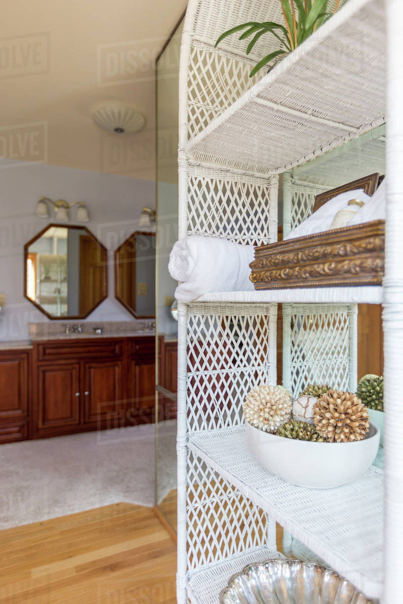 Wicker shelves outside bathroom Stock Photo Dissolve