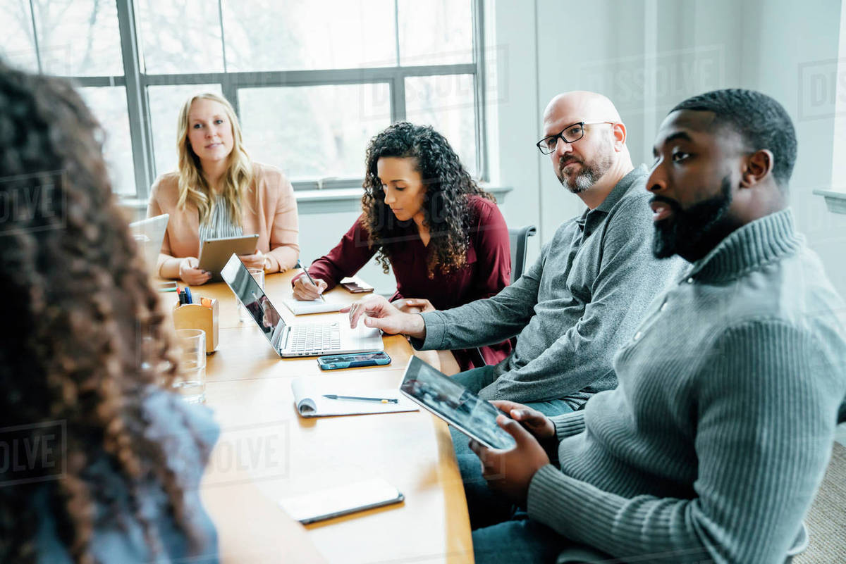 Business people listening in meeting Stock Photo Dissolve
