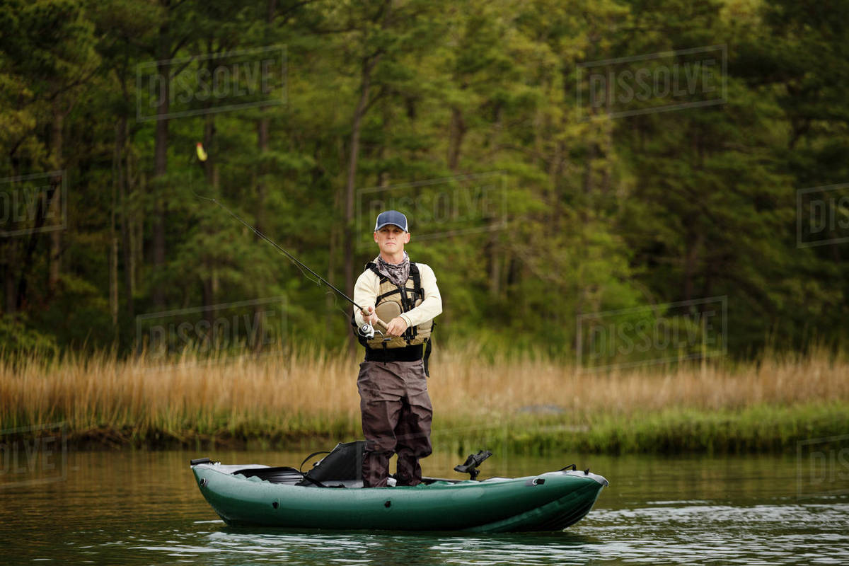 caucasian man fishing on kayak stock photo dissolve