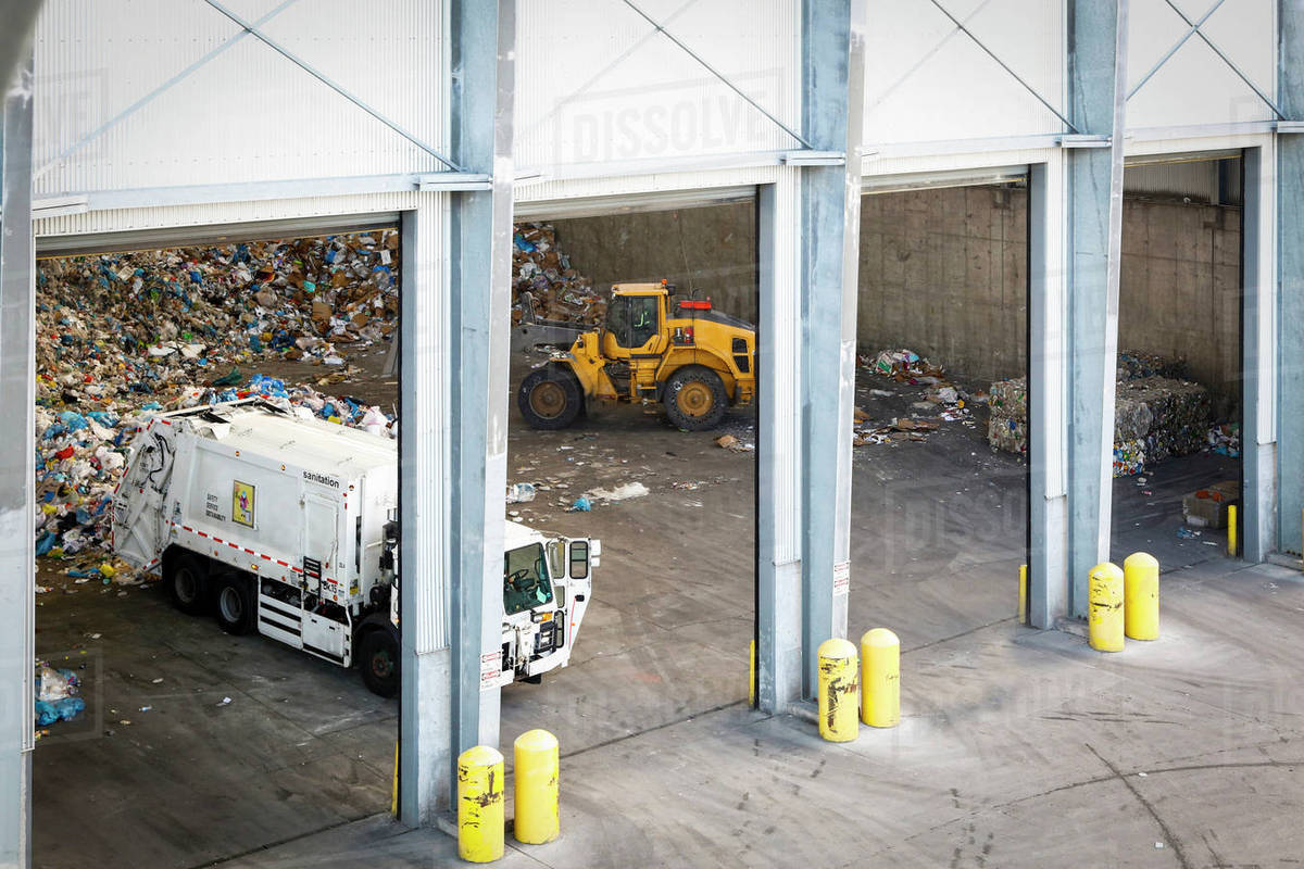 Garbage truck unloading trash Stock Photo Dissolve