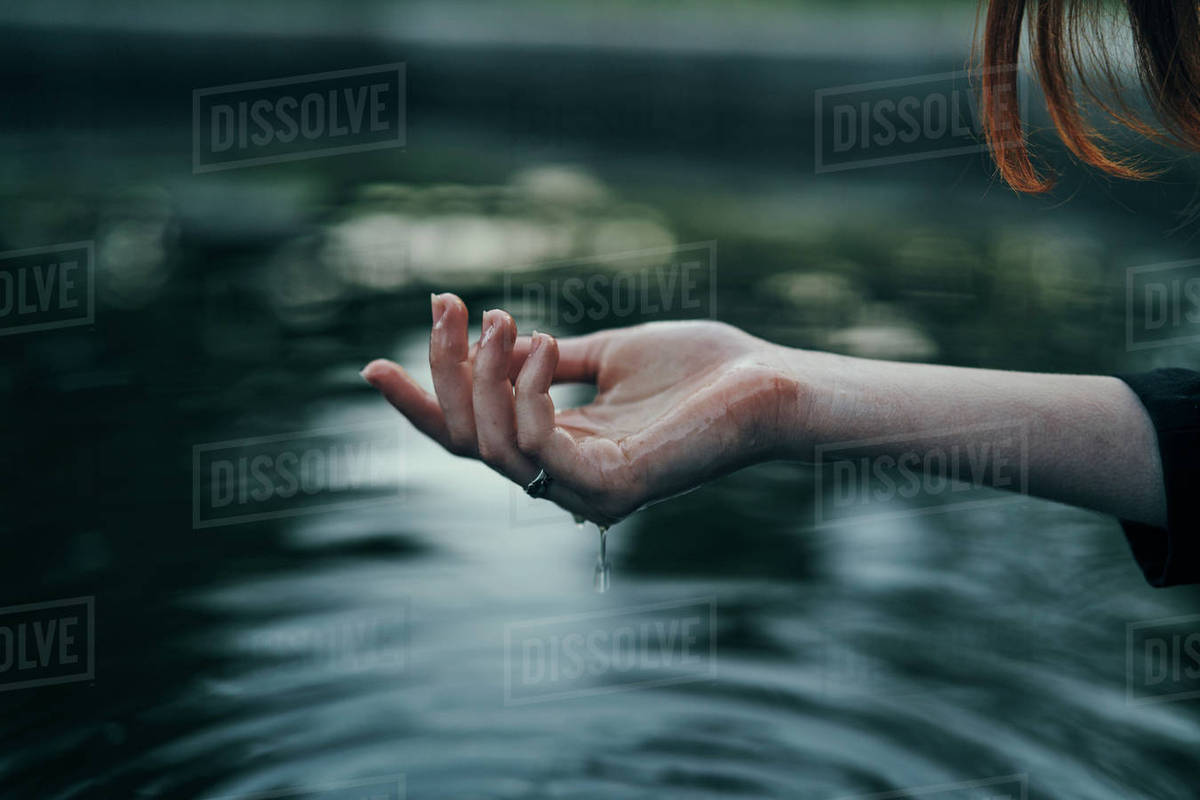 Water dripping from hand of woman Stock Photo Dissolve