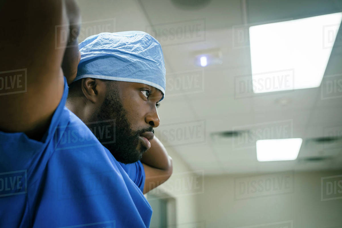 Black doctor wearing surgical cap Stock Photo Dissolve