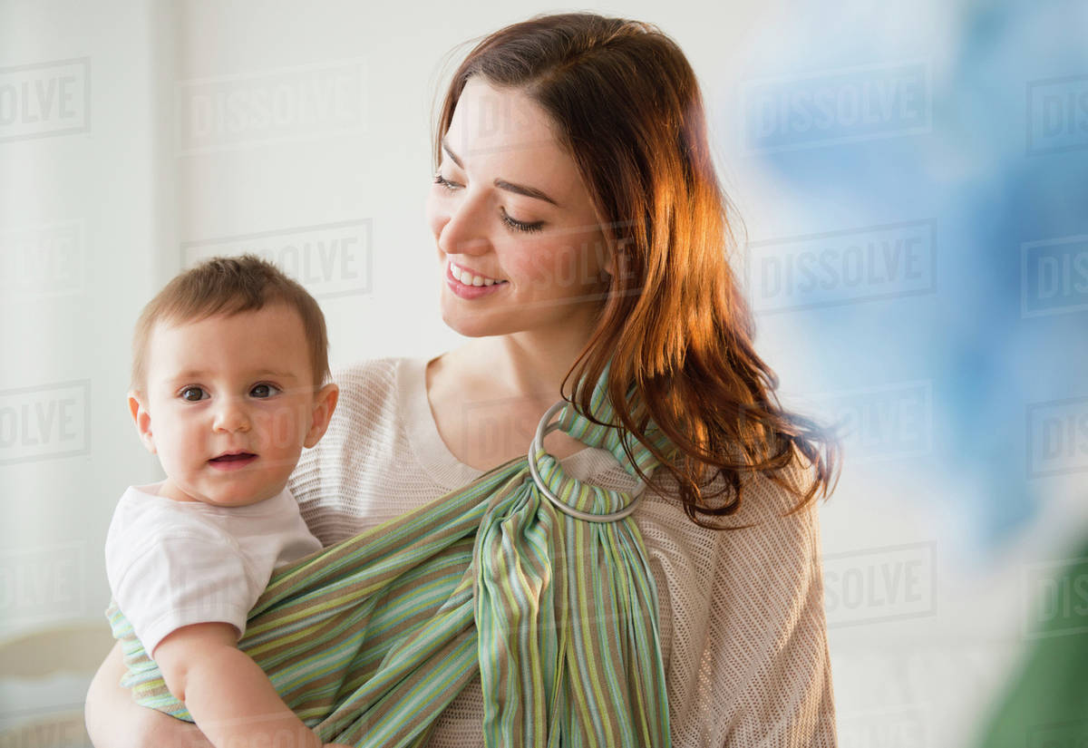 Mother carrying baby in sling Stock Photo Dissolve