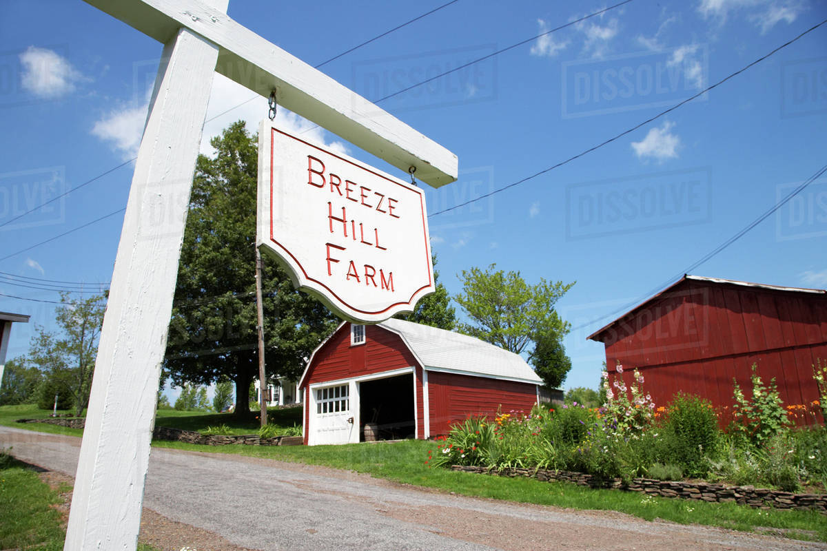 'Breeze Hill Farm' sign on rural road Stock Photo Dissolve