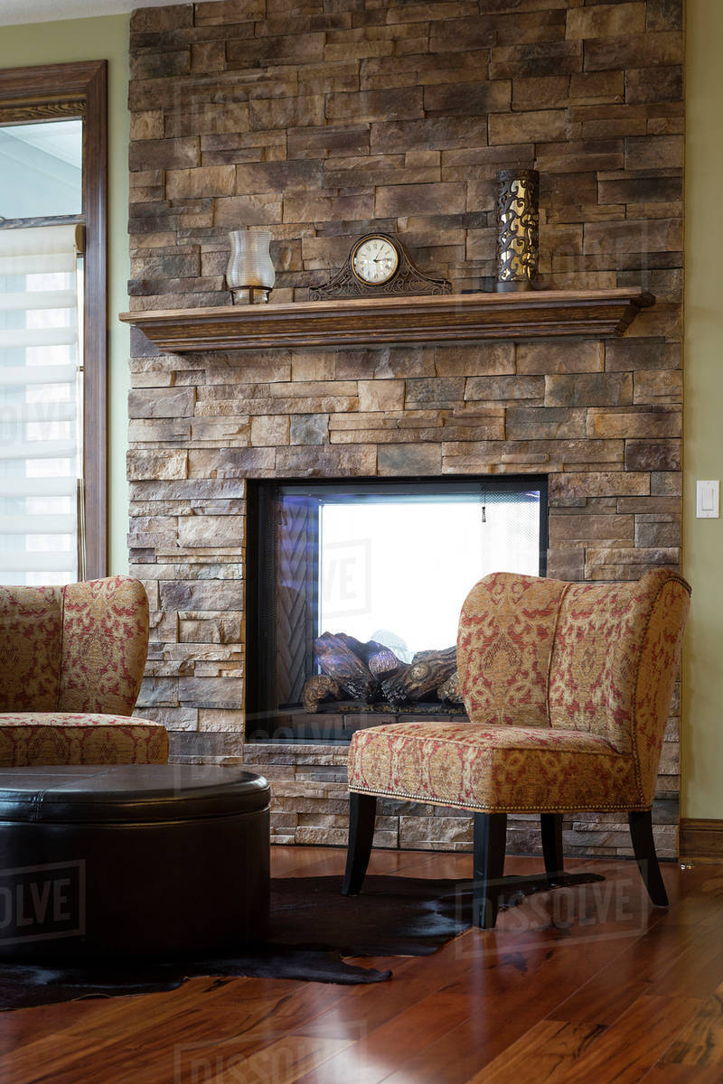 Chairs and fireplace in living room Stock Photo Dissolve