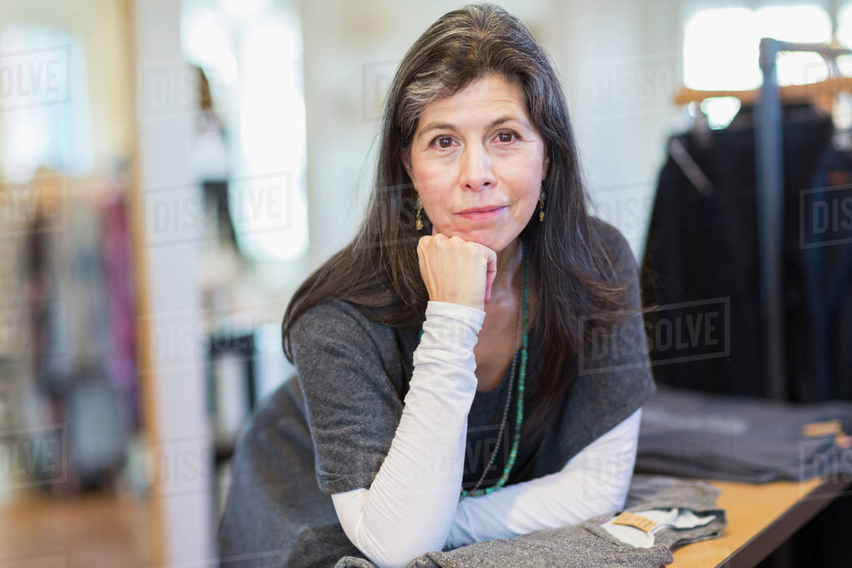 Hispanic small business owner smiling in store Royalty-free stock photo