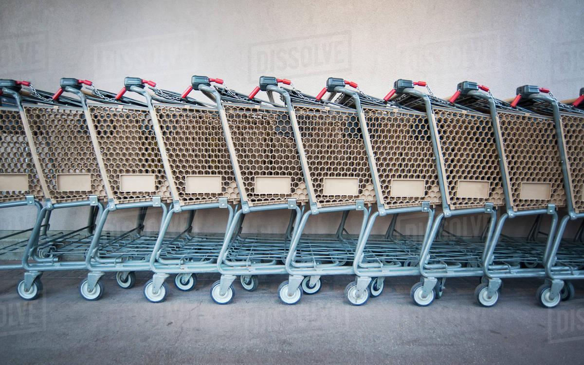 Connected shopping carts in a row - Stock Photo - Dissolve
