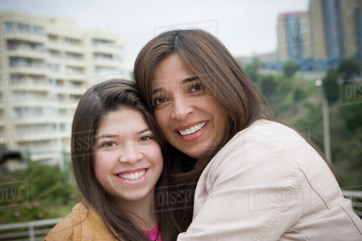 hispanic-mother-and-daughter-smiling-outdoors-stock-photo-dissolve