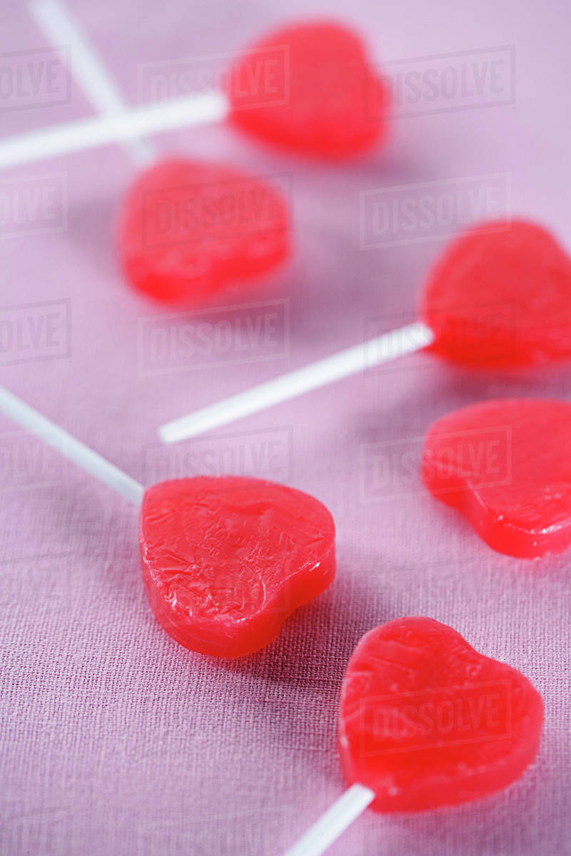 Group of red heart-shape lollipops - Stock Photo - Dissolve