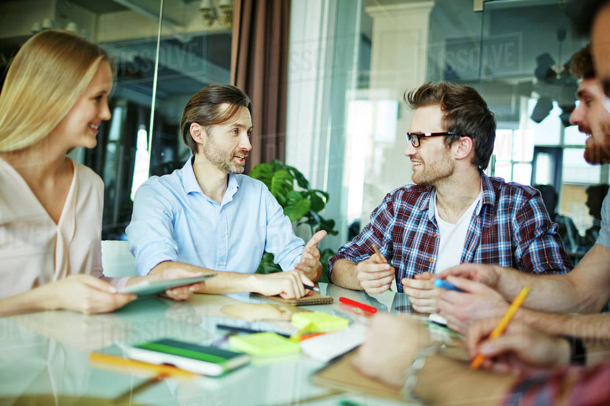 Group of business people discussing plans at the table - Royalty-free ...